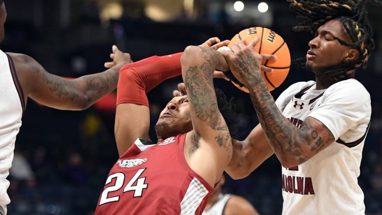 Mar 14, 2024; Nashville, TN, USA; Arkansas Razorbacks guard Jeremiah Davenport (24) tries to grab a rebound against South Carolina Gamecocks guard Zachary Davis (12) during the first half at Bridgestone Arena. Mandatory Credit: Christopher Hanewinckel-USA TODAY Sports