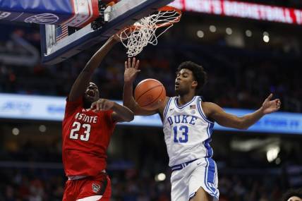 Mar 14, 2024; Washington, D.C., USA; North Carolina State forward Mohamed Diarra (23) dunks the ball as Duke Blue Devils forward Sean Stewart (13) defends in the first half at Capital One Arena. Mandatory Credit: Geoff Burke-USA TODAY Sports