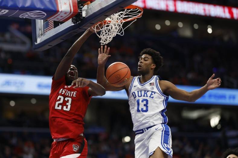 Mar 14, 2024; Washington, D.C., USA; North Carolina State forward Mohamed Diarra (23) dunks the ball as Duke Blue Devils forward Sean Stewart (13) defends in the first half at Capital One Arena. Mandatory Credit: Geoff Burke-USA TODAY Sports