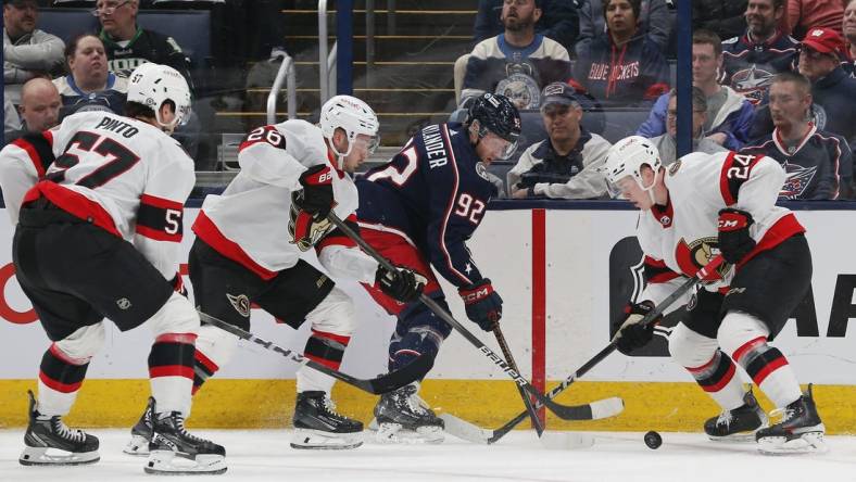 Mar 14, 2024; Columbus, Ohio, USA; Columbus Blue Jackets left wing Alexander Nylander (92) battles with Ottawa Senators defenseman Jacob Bernard-Docker (24) for the puck during the first period at Nationwide Arena. Mandatory Credit: Russell LaBounty-USA TODAY Sports