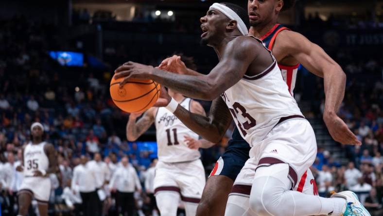 Texas A&M Aggies guard Tyrece Radford (23) drives to the bucket against Mississippi Rebels forward Jaemyn Brakefield (4) during their second round game of the SEC Men's Basketball Tournament at Bridgestone Arena in Nashville, Tenn., Thursday, March 14, 2024.