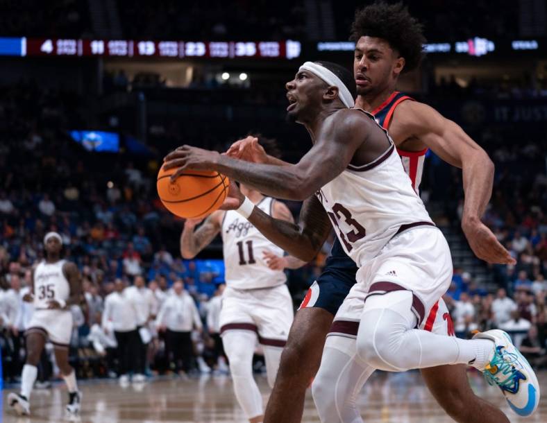 Texas A&M Aggies guard Tyrece Radford (23) drives to the bucket against Mississippi Rebels forward Jaemyn Brakefield (4) during their second round game of the SEC Men's Basketball Tournament at Bridgestone Arena in Nashville, Tenn., Thursday, March 14, 2024.