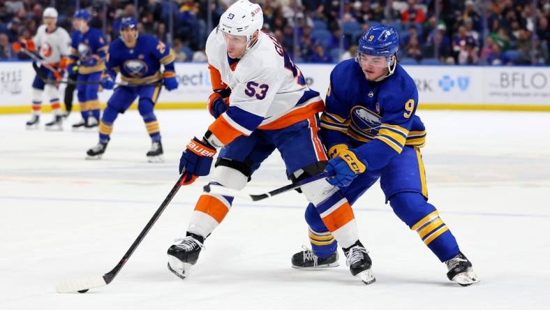 Mar 14, 2024; Buffalo, New York, USA;  New York Islanders center Casey Cizikas (53) controls the puck as Buffalo Sabres left wing Zach Benson (9) defends during the second period at KeyBank Center. Mandatory Credit: Timothy T. Ludwig-USA TODAY Sports