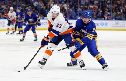 Mar 14, 2024; Buffalo, New York, USA;  New York Islanders center Casey Cizikas (53) controls the puck as Buffalo Sabres left wing Zach Benson (9) defends during the second period at KeyBank Center. Mandatory Credit: Timothy T. Ludwig-USA TODAY Sports