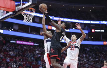 Mar 14, 2024; Houston, Texas, USA; Houston Rockets guard Jalen Green (4) drives to the basket as Washington Wizards guard Bilal Coulibaly (0) defends during the second quarter at Toyota Center. Mandatory Credit: Troy Taormina-USA TODAY Sports