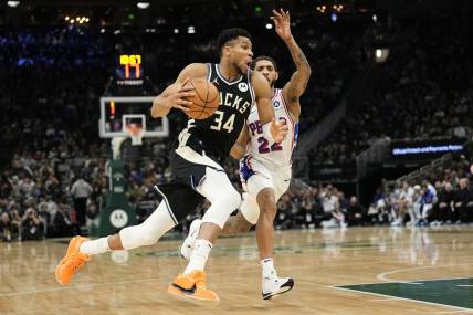 Mar 14, 2024; Milwaukee, Wisconsin, USA;  Milwaukee Bucks forward Giannis Antetokounmpo (34) drives for the basket in front of Philadelphia 76ers guard Cameron Payne (22) during the second quarter at Fiserv Forum. Mandatory Credit: Jeff Hanisch-USA TODAY Sports
