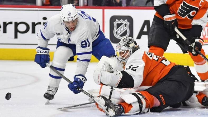 Mar 14, 2024; Philadelphia, Pennsylvania, USA; Philadelphia Flyers goaltender Felix Sandstrom (32) makes a save against Toronto Maple Leafs center John Tavares (91) during the second period at Wells Fargo Center. Mandatory Credit: Eric Hartline-USA TODAY Sports