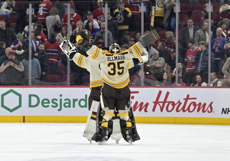 Mar 14, 2024; Montreal, Quebec, CAN; Boston Bruins goalie Linus Ullmark (35) celebrates with teammate goalie Jeremy Swayman (1) the win against the Montreal Canadiens in overtime at the Bell Centre. Mandatory Credit: Eric Bolte-USA TODAY Sports