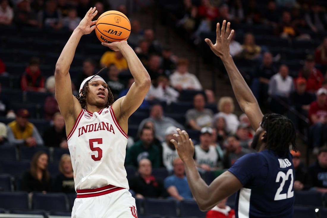 Mar 14, 2024; Minneapolis, MN, USA; Indiana Hoosiers forward Malik Reneau (5) shoots as Penn State Nittany Lions forward Qudus Wahab (22) defends during the first half at Target Center. Mandatory Credit: Matt Krohn-USA TODAY Sports