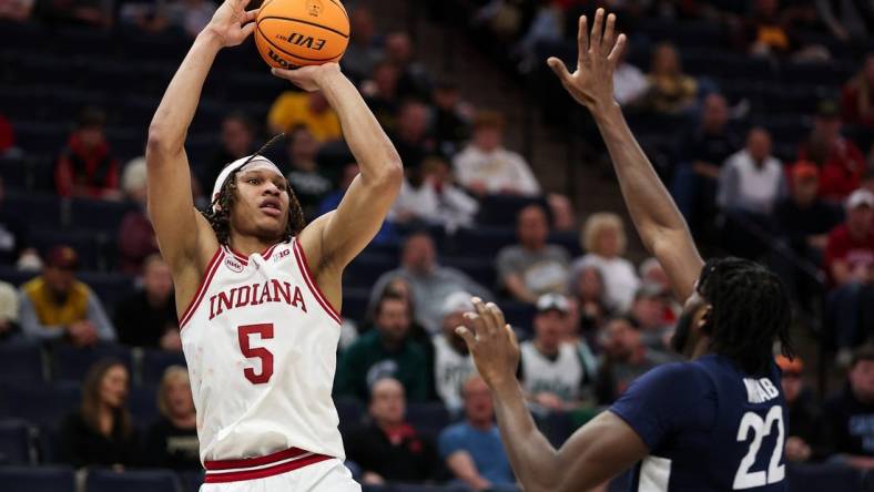 Mar 14, 2024; Minneapolis, MN, USA; Indiana Hoosiers forward Malik Reneau (5) shoots as Penn State Nittany Lions forward Qudus Wahab (22) defends during the first half at Target Center. Mandatory Credit: Matt Krohn-USA TODAY Sports