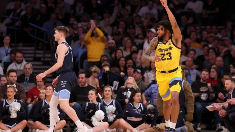 Mar 14, 2024; New York City, NY, USA; Marquette Golden Eagles forward David Joplin (23) celebrates his three point shot against Villanova Wildcats guard Brendan Hausen (1) during the first half at Madison Square Garden. Mandatory Credit: Brad Penner-USA TODAY Sports