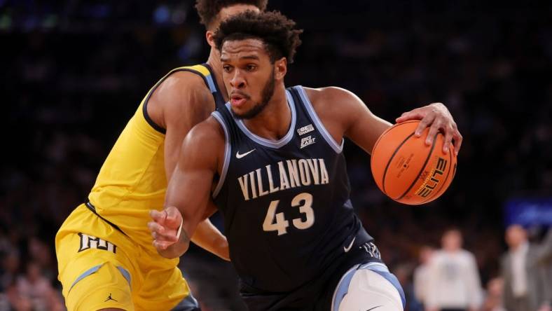 Mar 14, 2024; New York City, NY, USA; Villanova Wildcats forward Eric Dixon (43) drives to the basket against Marquette Golden Eagles forward Oso Ighodaro (13) during the first half at Madison Square Garden. Mandatory Credit: Brad Penner-USA TODAY Sports