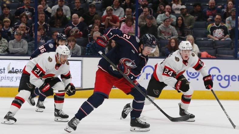 Mar 14, 2024; Columbus, Ohio, USA; Columbus Blue Jackets center Alexander Texier (42) grabs a loose puck as Ottawa Senators defenseman Jacob Bernard-Docker (24) trails the play during the third period at Nationwide Arena. Mandatory Credit: Russell LaBounty-USA TODAY Sports