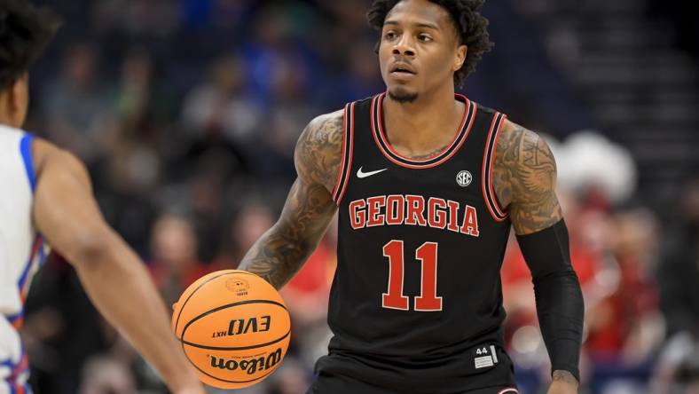 Mar 14, 2024; Nashville, TN, USA;  Georgia Bulldogs guard Justin Hill (11) dribbles against the Florida Gators during the first half at Bridgestone Arena. Mandatory Credit: Steve Roberts-USA TODAY Sports