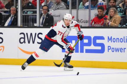 Mar 14, 2024; Seattle, Washington, USA; Washington Capitals right wing T.J. Oshie (77) plays the puck during the third period against the Seattle Kraken at Climate Pledge Arena. Mandatory Credit: Steven Bisig-USA TODAY Sports