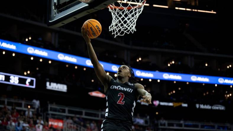 Cincinnati Bearcats guard Jizzle James (2) hits a layup in the second half of the Big 12 Conference tournament game between Cincinnati Bearcats and Baylor Bears at T-Mobile Center in Kansas City, Mo., on Thursday, March 14, 2024.