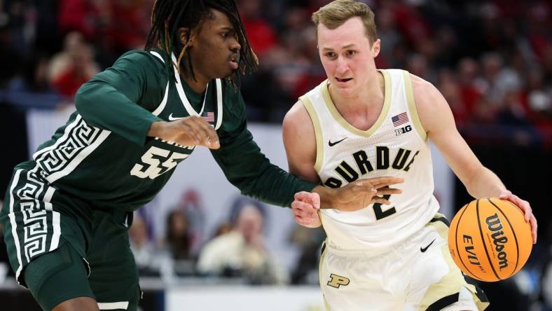 Mar 15, 2024; Minneapolis, MN, USA; Purdue Boilermakers guard Fletcher Loyer (2) works around Michigan State Spartans forward Coen Carr (55) during the first half at Target Center. Mandatory Credit: Matt Krohn-USA TODAY Sports