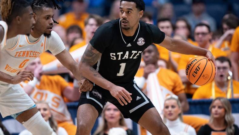 Mississippi State Bulldogs forward Tolu Smith (1) drives against Tennessee Volunteers forward Jonas Aidoo (0) during their SEC Men's Basketball Tournament quarterfinal game at Bridgestone Arena in Nashville, Tenn., Friday, March 15, 2024.