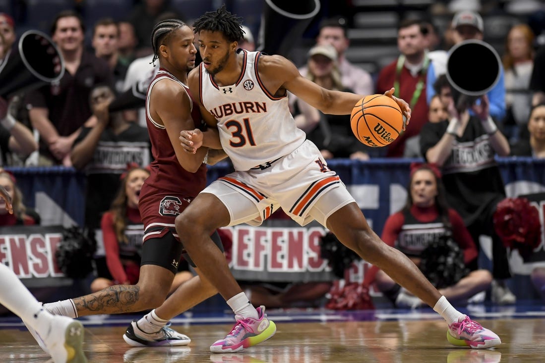 Mar 15, 2024; Nashville, TN, USA; Auburn Tigers guard Chaney Johnson (31) backs down South Carolina Gamecocks forward Josh Gray (33) during the first half at Bridgestone Arena. Mandatory Credit: Steve Roberts-USA TODAY Sports