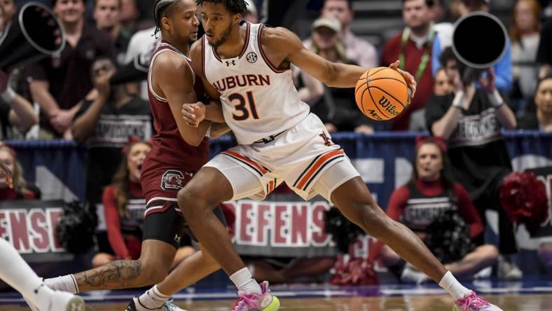 Mar 15, 2024; Nashville, TN, USA; Auburn Tigers guard Chaney Johnson (31) backs down South Carolina Gamecocks forward Josh Gray (33) during the first half at Bridgestone Arena. Mandatory Credit: Steve Roberts-USA TODAY Sports