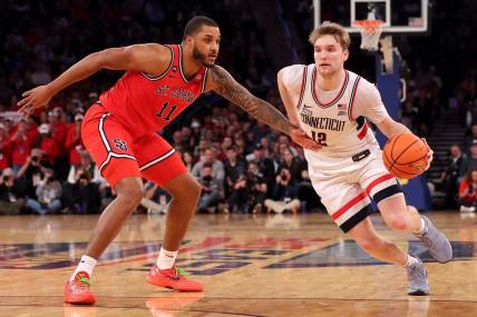 Mar 15, 2024; New York City, NY, USA; Connecticut Huskies guard Cam Spencer (12) drives to the basket against St. John's Red Storm center Joel Soriano (11) during the second half at Madison Square Garden. Mandatory Credit: Brad Penner-USA TODAY Sports