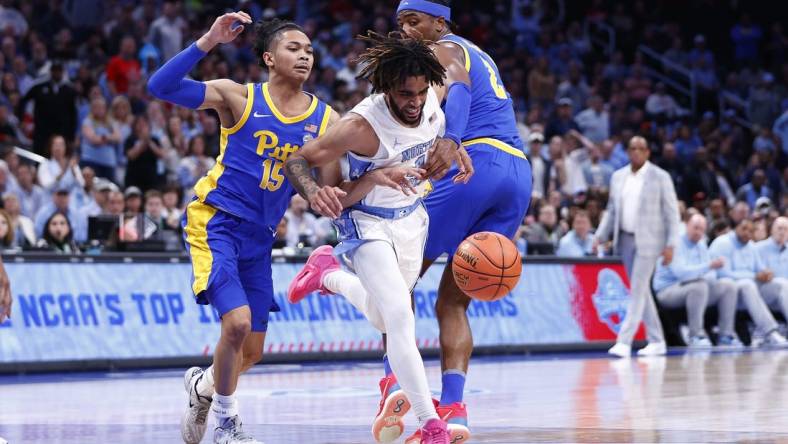 Mar 15, 2024; Washington, D.C., USA; North Carolina Tar Heels guard RJ Davis (4) looses control of the ball as Pittsburgh Panthers guard Jaland Lowe (15) and Panthers forward Blake Hinson (2) defend during the first half at Capital One Arena. Mandatory Credit: Amber Searls-USA TODAY Sports