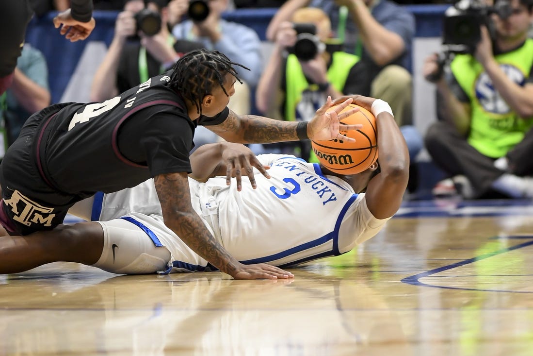 Mar 15, 2024; Nashville, TN, USA; Texas A&M Aggies guard Wade Taylor IV (4) and Kentucky Wildcats guard Adou Thiero (3) fight for the loose ball during the first half at Bridgestone Arena. Mandatory Credit: Steve Roberts-USA TODAY Sports