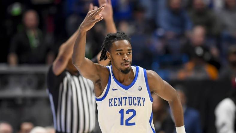 Mar 15, 2024; Nashville, TN, USA; Kentucky Wildcats guard Antonio Reeves (12) celebrates his three point basket against the Texas A&M Aggies during the first half at Bridgestone Arena. Mandatory Credit: Steve Roberts-USA TODAY Sports