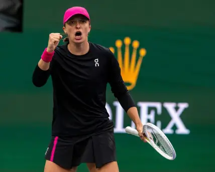 Iga Swiatek celebrates winning the fifth game of the second set against Marta Kostyuk during the WTA semifinals of the BNP Paribas Open in Indian Wells, Calif., Friday, March 15, 2024.