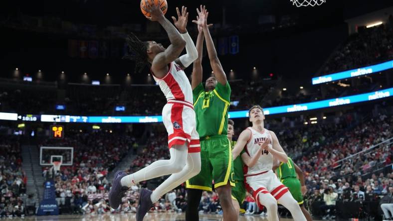 Mar 15, 2024; Las Vegas, NV, USA; Arizona Wildcats guard Caleb Love (2) shoots the ball against Oregon Ducks forward Kwame Evans Jr. (10) in the first half at T-Mobile Arena. Mandatory Credit: Kirby Lee-USA TODAY Sports