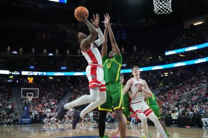 Mar 15, 2024; Las Vegas, NV, USA; Arizona Wildcats guard Caleb Love (2) shoots the ball against Oregon Ducks forward Kwame Evans Jr. (10) in the first half at T-Mobile Arena. Mandatory Credit: Kirby Lee-USA TODAY Sports