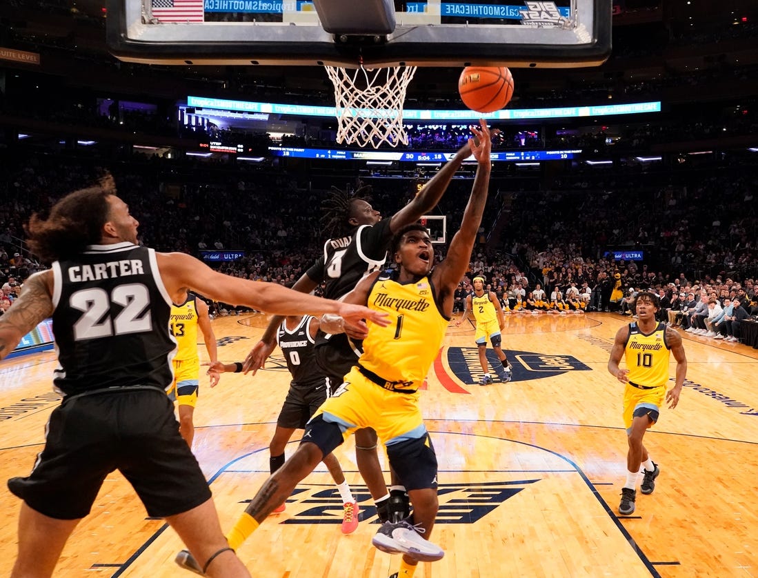 Mar 15, 2024; New York City, NY, USA;  Marquette Golden Eagles guard Kam Jones (1) shoots past Providence Friars guard Garwey Dual (3) during the first half at Madison Square Garden. Mandatory Credit: Robert Deutsch-USA TODAY Sports