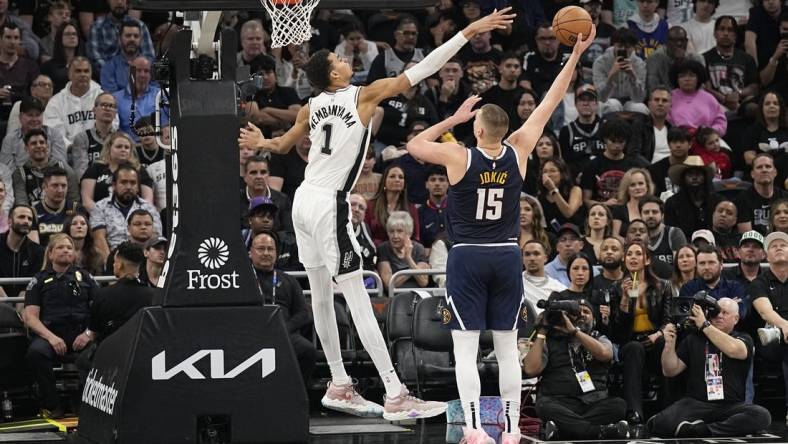 Mar 15, 2024; Austin, Texas, USA; Denver Nuggets center Nikola Jokic (15) shoots over San Antonio Spurs forward Victor Wembanyama (1) during the first half at Moody Center. Mandatory Credit: Scott Wachter-USA TODAY Sports