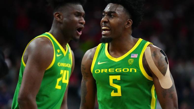 Mar 15, 2024; Las Vegas, NV, USA; Oregon Ducks guard Jermaine Couisnard (5) and forward Mahamadou Diawara (24) celebrate against the Arizona Wildcats in the second half at T-Mobile Arena. Mandatory Credit: Kirby Lee-USA TODAY Sports