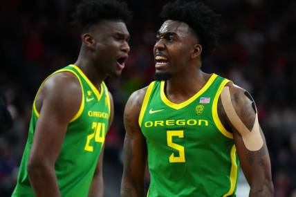 Mar 15, 2024; Las Vegas, NV, USA; Oregon Ducks guard Jermaine Couisnard (5) and forward Mahamadou Diawara (24) celebrate against the Arizona Wildcats in the second half at T-Mobile Arena. Mandatory Credit: Kirby Lee-USA TODAY Sports