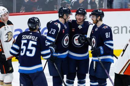 Mar 15, 2024; Winnipeg, Manitoba, CAN; Winnipeg Jets forward Tyler T0ffoli (73) is congratulated by his team mates on his goal against the Anaheim Ducks during the third period at Canada Life Centre. Mandatory Credit: Terrence Lee-USA TODAY Sports