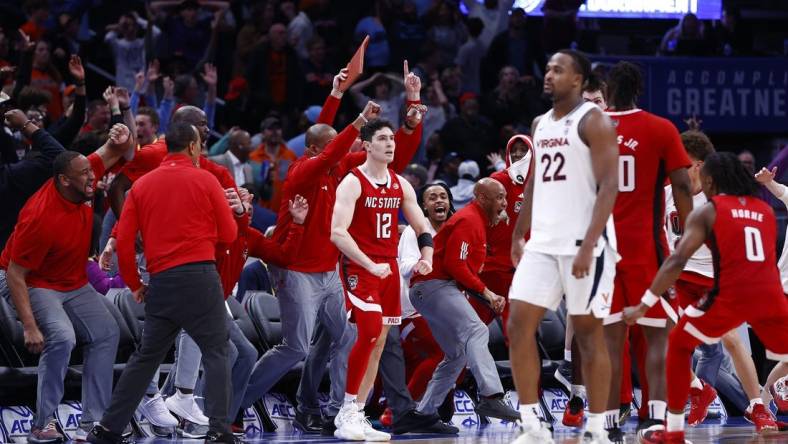 Mar 15, 2024; Washington, D.C., USA; North Carolina State Wolfpack guard Michael O'Connell (12) celebrates after shooting a three point shot at the buzzer during the second half against the Virginia Cavaliers at Capital One Arena. Mandatory Credit: Amber Searls-USA TODAY Sports