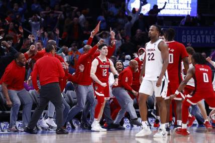 Mar 15, 2024; Washington, D.C., USA; North Carolina State Wolfpack guard Michael O'Connell (12) celebrates after shooting a three point shot at the buzzer during the second half against the Virginia Cavaliers at Capital One Arena. Mandatory Credit: Amber Searls-USA TODAY Sports