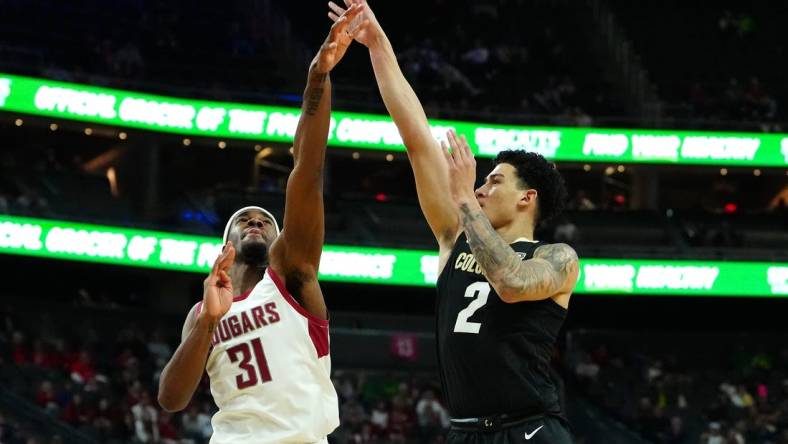 Mar 15, 2024; Las Vegas, NV, USA; Colorado Buffaloes guard KJ Simpson (2) shoots against Washington State Cougars guard Kymany Houinsou (31) during the first half at T-Mobile Arena. Mandatory Credit: Stephen R. Sylvanie-USA TODAY Sports