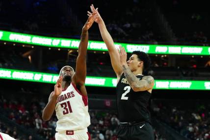 Mar 15, 2024; Las Vegas, NV, USA; Colorado Buffaloes guard KJ Simpson (2) shoots against Washington State Cougars guard Kymany Houinsou (31) during the first half at T-Mobile Arena. Mandatory Credit: Stephen R. Sylvanie-USA TODAY Sports