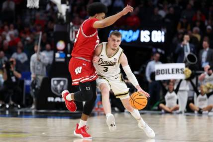 Mar 16, 2024; Minneapolis, MN, USA; Purdue Boilermakers guard Braden Smith (3) works up the court as Wisconsin Badgers guard Chucky Hepburn (23) defends during the first half at Target Center. Mandatory Credit: Matt Krohn-USA TODAY Sports