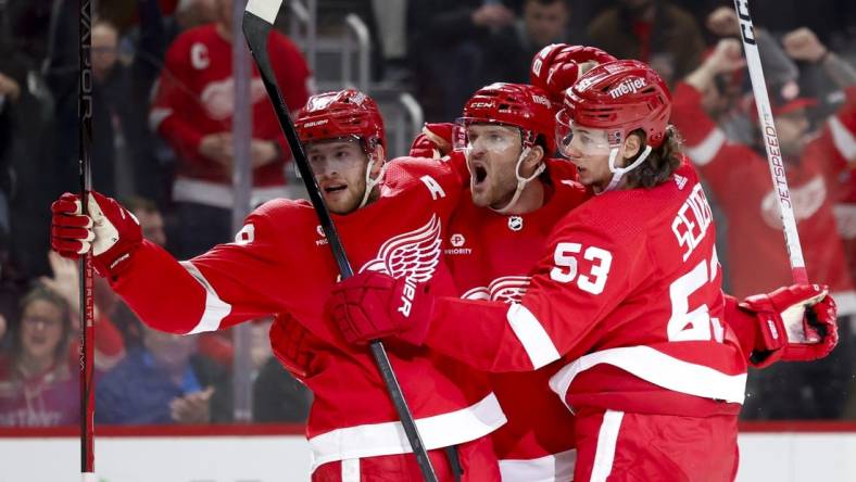 Mar 16, 2024; Detroit, Michigan, USA;  Detroit Red Wings right wing Christian Fischer (36) receives congratulations from center Andrew Copp (18) and defenseman Moritz Seider (53) after scoring in the second period against the Buffalo Sabres at Little Caesars Arena. Mandatory Credit: Rick Osentoski-USA TODAY Sports