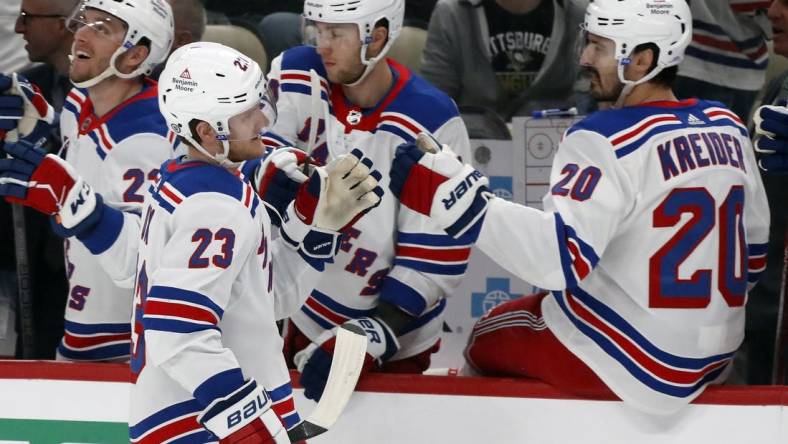 Mar 16, 2024; Pittsburgh, Pennsylvania, USA;  New York Rangers defenseman Adam Fox (23) celebrates his goal with the Rangers bench against the Pittsburgh Penguins during the first period at PPG Paints Arena. Mandatory Credit: Charles LeClaire-USA TODAY Sports