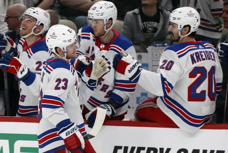 Mar 16, 2024; Pittsburgh, Pennsylvania, USA;  New York Rangers defenseman Adam Fox (23) celebrates his goal with the Rangers bench against the Pittsburgh Penguins during the first period at PPG Paints Arena. Mandatory Credit: Charles LeClaire-USA TODAY Sports