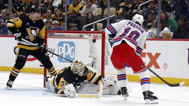 Mar 16, 2024; Pittsburgh, Pennsylvania, USA;  New York Rangers left wing Artemi Panarin (10) scores his second goal of the game against Pittsburgh Penguins goaltender Tristan Jarry (35) during the second period at PPG Paints Arena. Mandatory Credit: Charles LeClaire-USA TODAY Sports