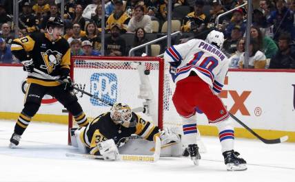 Mar 16, 2024; Pittsburgh, Pennsylvania, USA;  New York Rangers left wing Artemi Panarin (10) scores his second goal of the game against Pittsburgh Penguins goaltender Tristan Jarry (35) during the second period at PPG Paints Arena. Mandatory Credit: Charles LeClaire-USA TODAY Sports