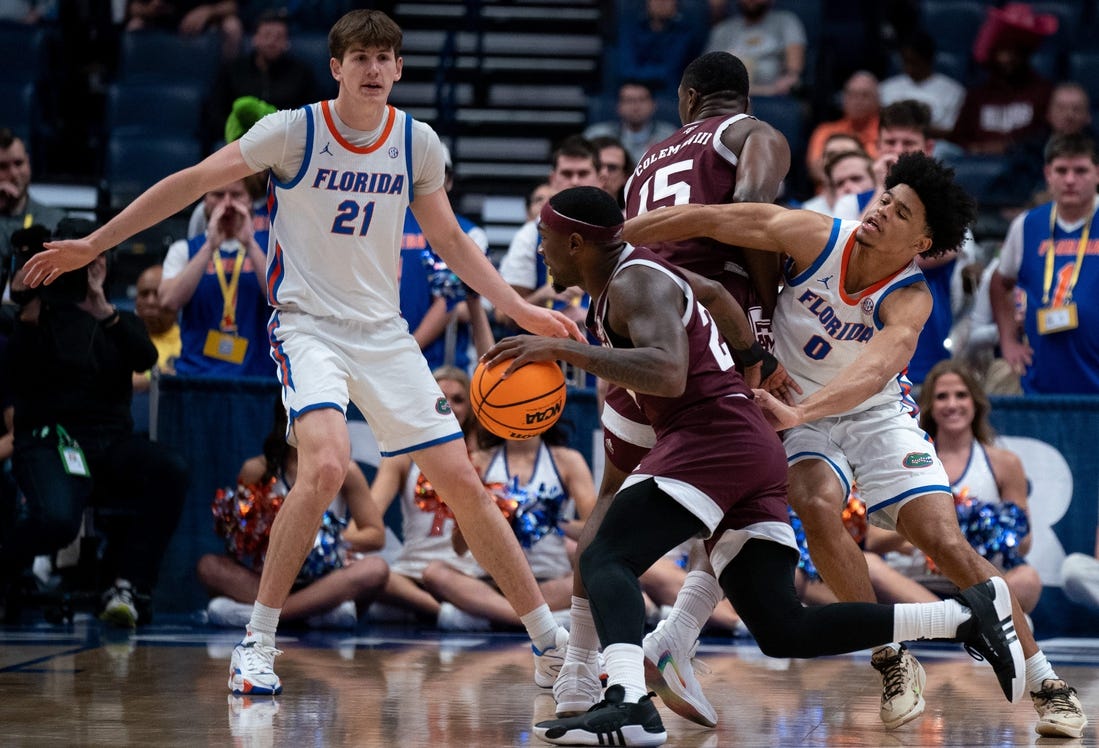 Texas A&M Aggies forward Henry Coleman III (15) sets a pick on Florida Gators guard Zyon Pullin (0) to free up Texas A&M Aggies guard Tyrece Radford (23) during their SEC Men's Basketball Tournament semifinal game at Bridgestone Arena in Nashville, Tenn., Saturday, March 16, 202 at Bridgestone Arena in Nashville, Tenn., Saturday, March 16, 2024.