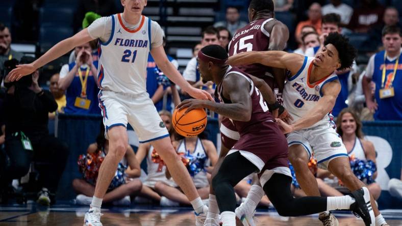 Texas A&M Aggies forward Henry Coleman III (15) sets a pick on Florida Gators guard Zyon Pullin (0) to free up Texas A&M Aggies guard Tyrece Radford (23) during their SEC Men's Basketball Tournament semifinal game at Bridgestone Arena in Nashville, Tenn., Saturday, March 16, 202 at Bridgestone Arena in Nashville, Tenn., Saturday, March 16, 2024.