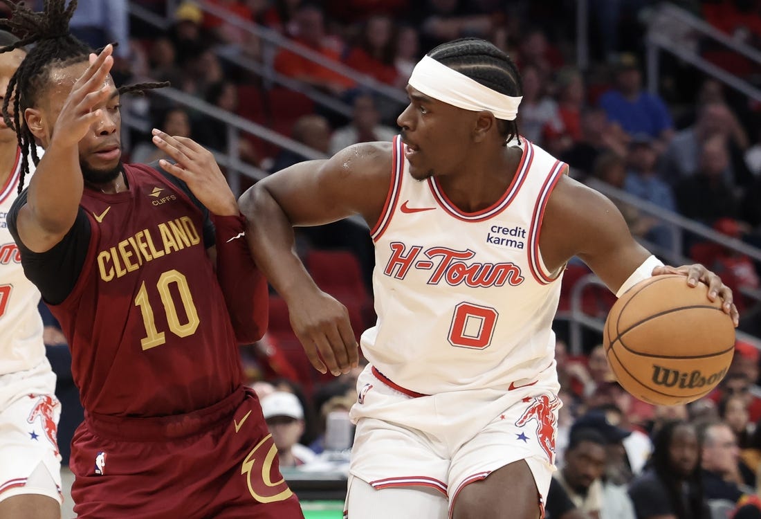 Mar 16, 2024; Houston, Texas, USA;  Houston Rockets guard Aaron Holiday (0) dribbles against Cleveland Cavaliers guard Darius Garland (10) in the second quarter at Toyota Center. Mandatory Credit: Thomas Shea-USA TODAY Sports
