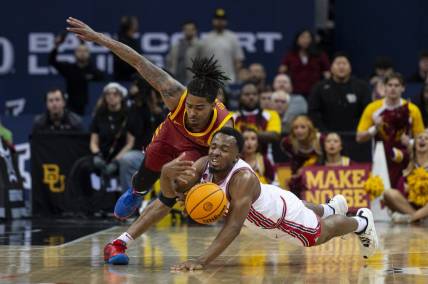 Mar 16, 2024; Kansas City, MO, USA; Iowa State Cyclones guard Keshon Gilbert (10) and Houston Cougars guard LJ Cryer (4) dive for a loose ball in the first half at T-Mobile Center. Mandatory Credit: Amy Kontras-USA TODAY Sports